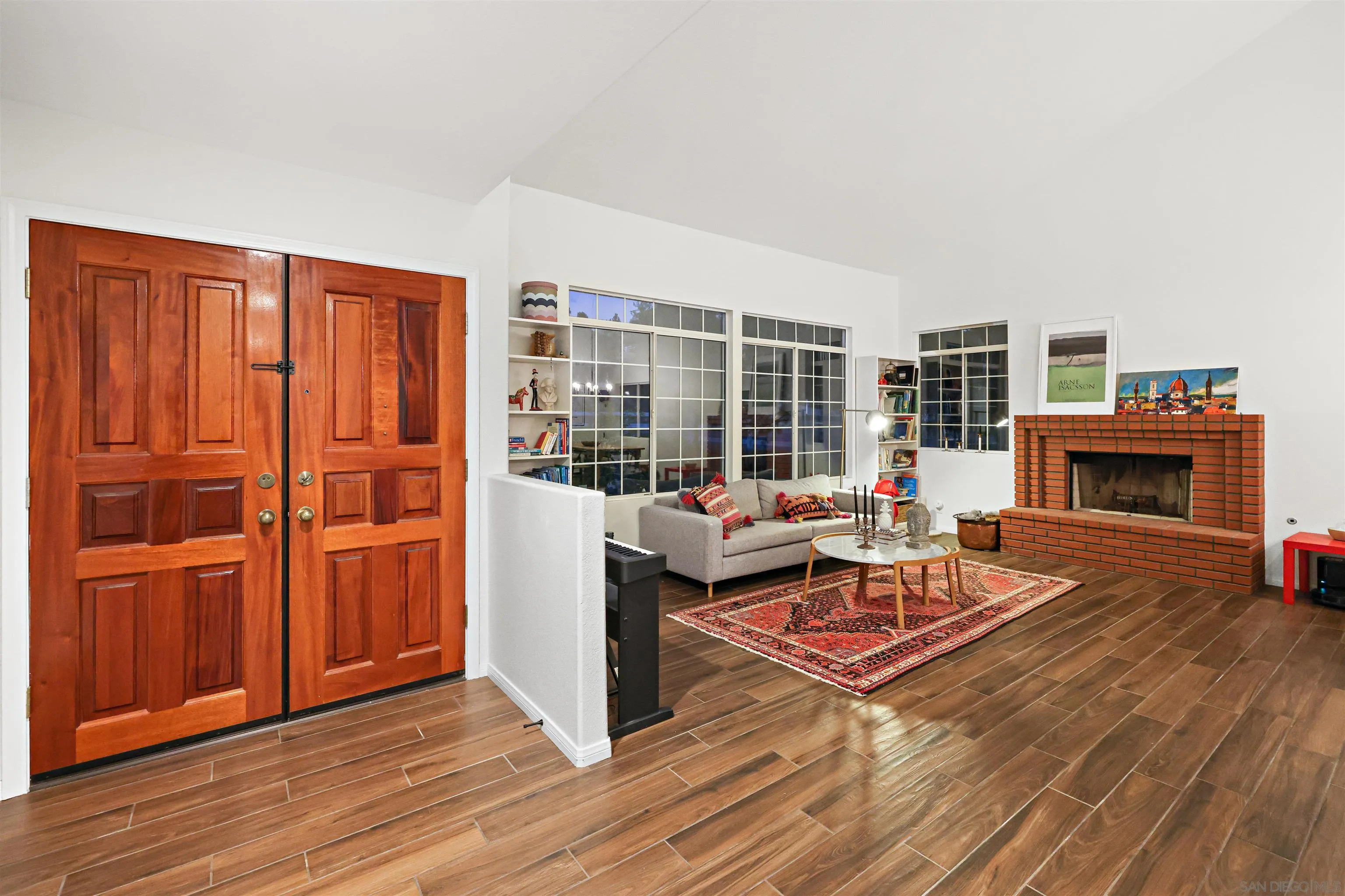 2457 Victoria Circle Alpine, CA 91901 - Photo 6 of 40 a living room with furniture a fireplace and wooden floor