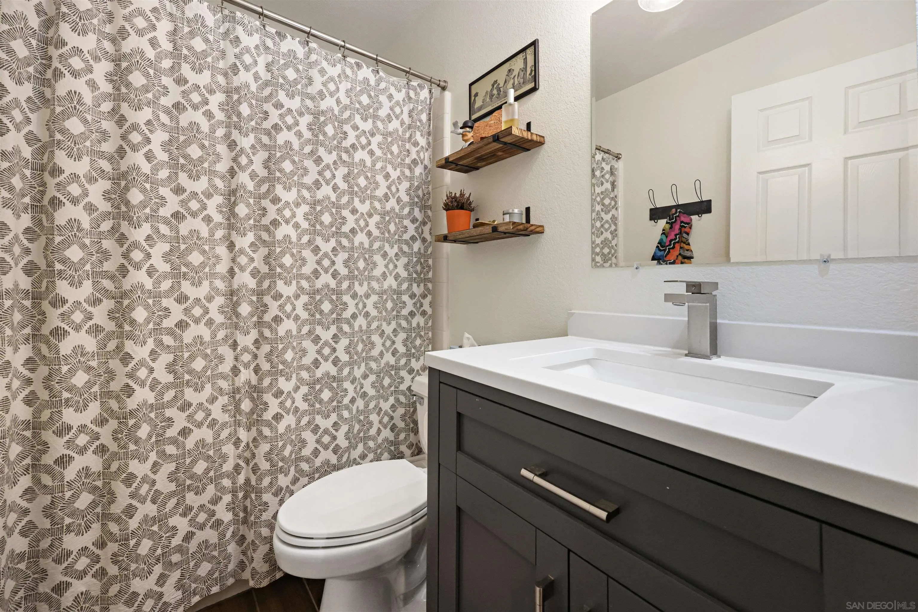 2457 Victoria Circle Alpine, CA 91901 - Photo 8 of 40 a bathroom with a granite countertop sink and a toilet