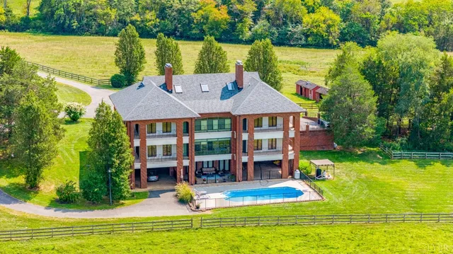 a aerial view of a house with swimming pool garden and patio