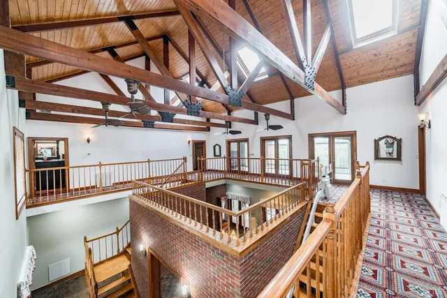 a bathroom with a granite countertop sink a mirror and a shower