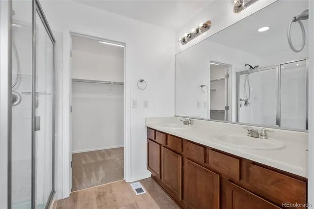 a bathroom with a sink double vanity and a mirror