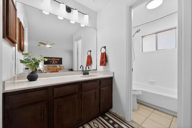 a bathroom with a double vanity sink a mirror and a bathtub