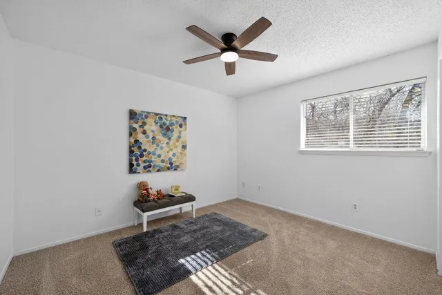 a very nice looking room with a ceiling fan