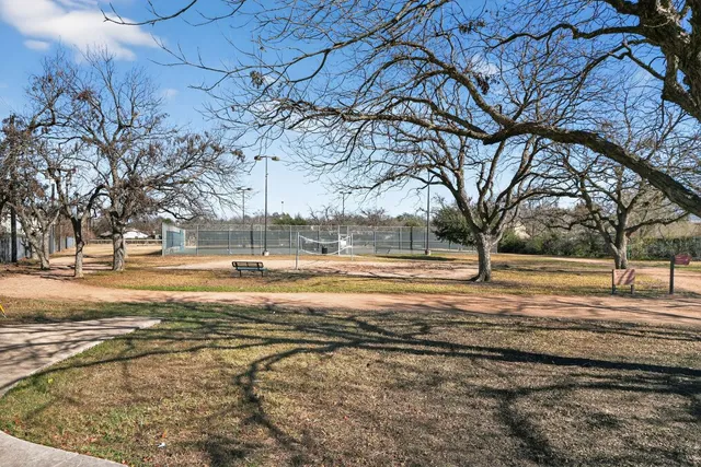 a view of yard with large trees