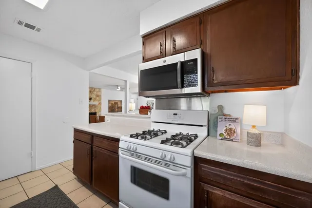a kitchen with cabinets and appliances