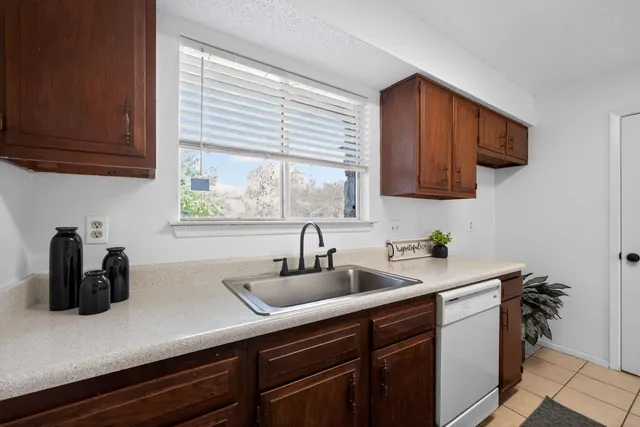 a kitchen with a sink cabinets and window