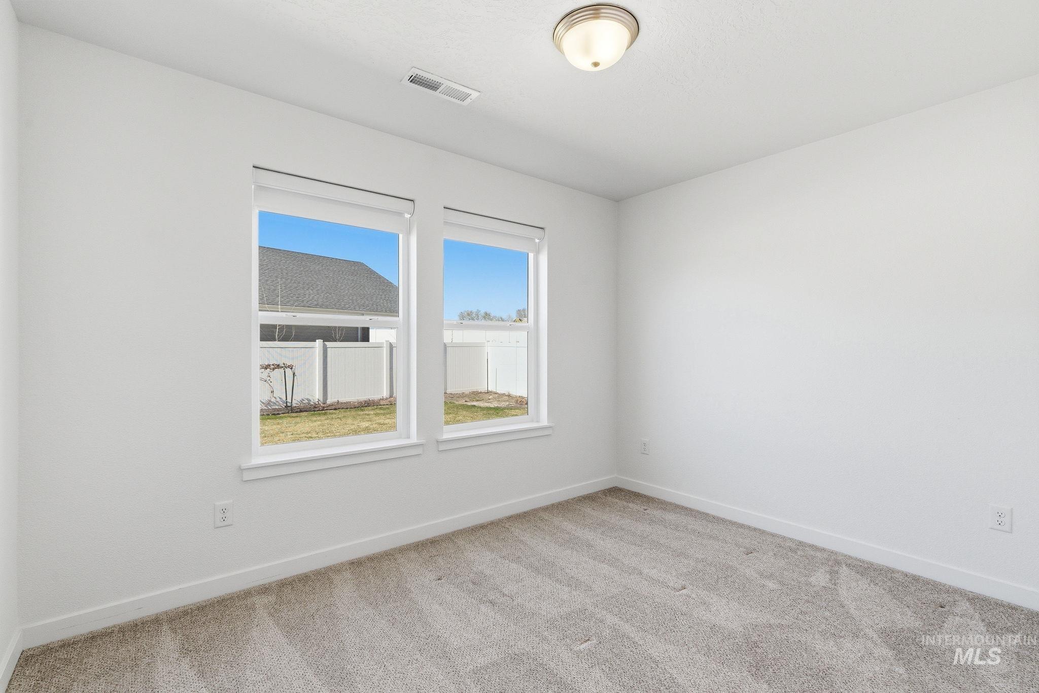 110 Homesteaders Street Middleton, ID 83644 - Photo 18 of 49 Unfurnished room featuring baseboards and light carpet