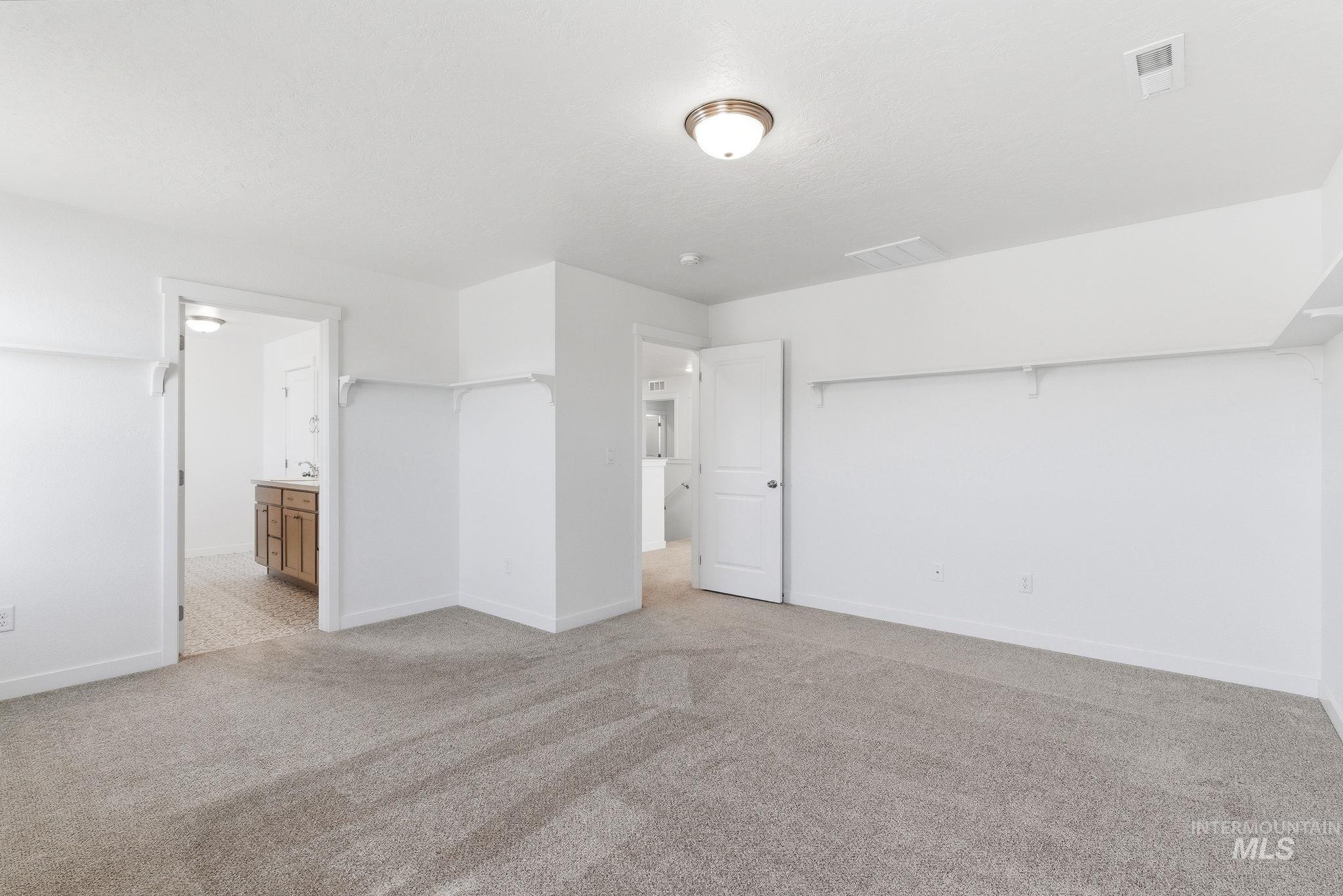 110 Homesteaders Street Middleton, ID 83644 - Photo 23 of 49 Unfurnished bedroom with light colored carpet and ensuite bathroom