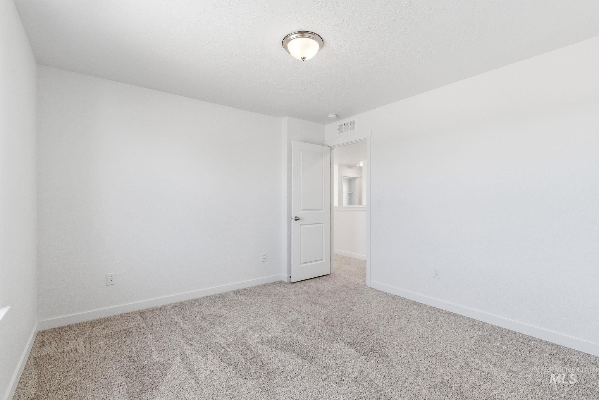 110 Homesteaders Street Middleton, ID 83644 - Photo 26 of 49 Unfurnished room with light carpet and baseboards