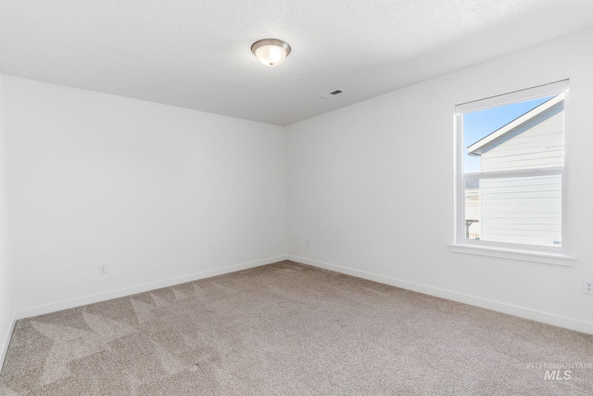 110 Homesteaders Street Middleton, ID 83644 - Photo 28 of 49 Spare room with light carpet and baseboards