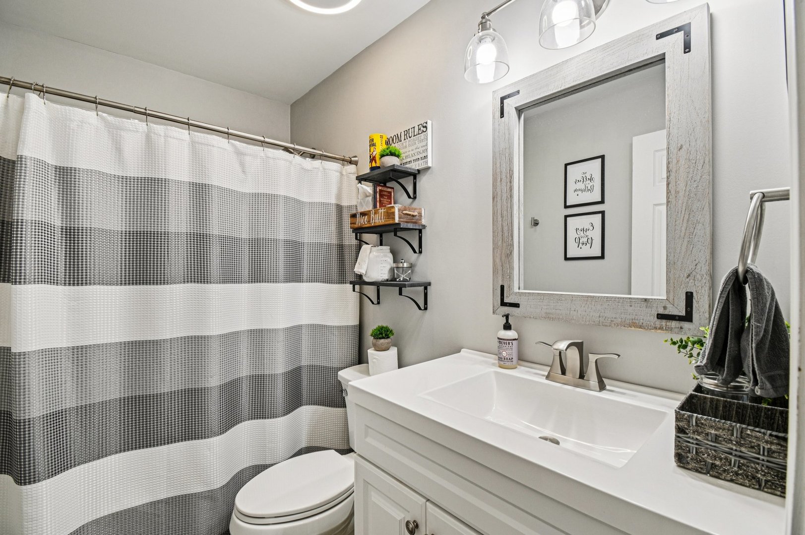 2223 Rockefeller Drive Geneva, IL 60134 - Photo 21 of 30 a bathroom with a sink a toilet and shower curtain