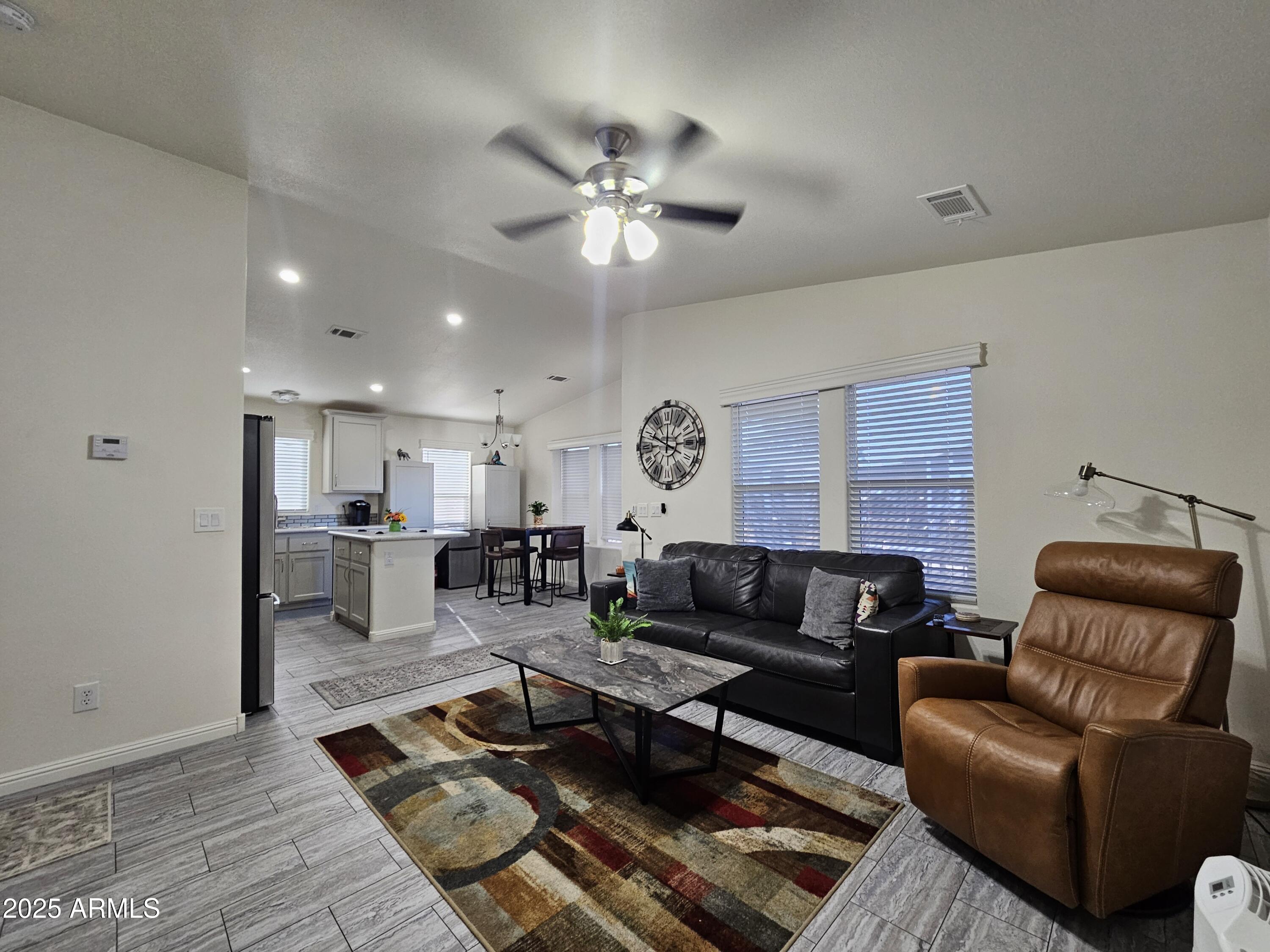 650 North Hawes Road, Unit 3124 Mesa, AZ 85207 - Photo 17 of 45 a living room with furniture and a chandelier