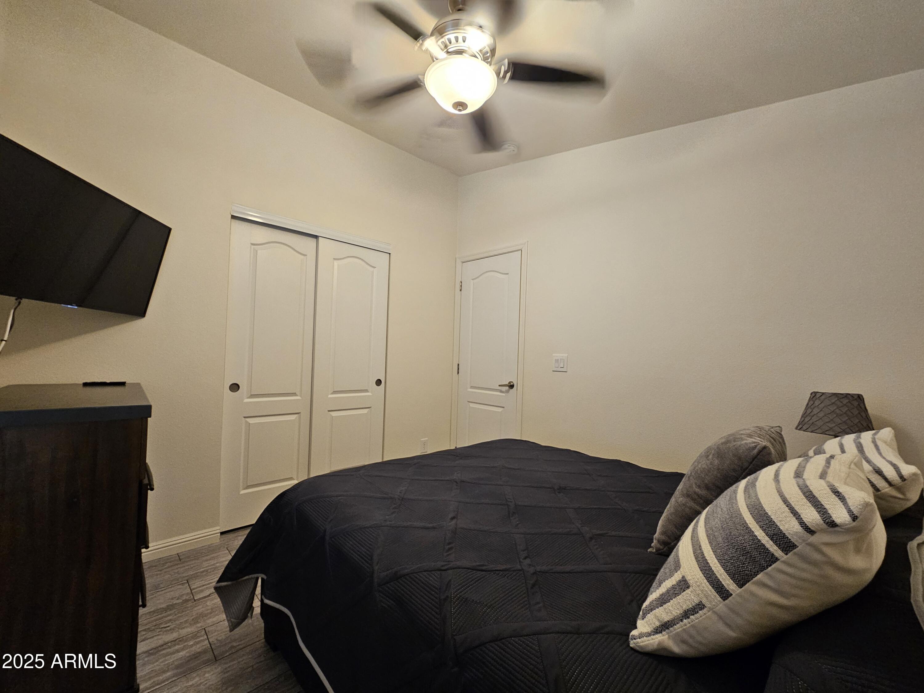 650 North Hawes Road, Unit 3124 Mesa, AZ 85207 - Photo 23 of 45 a bedroom with a bed and a flat screen tv