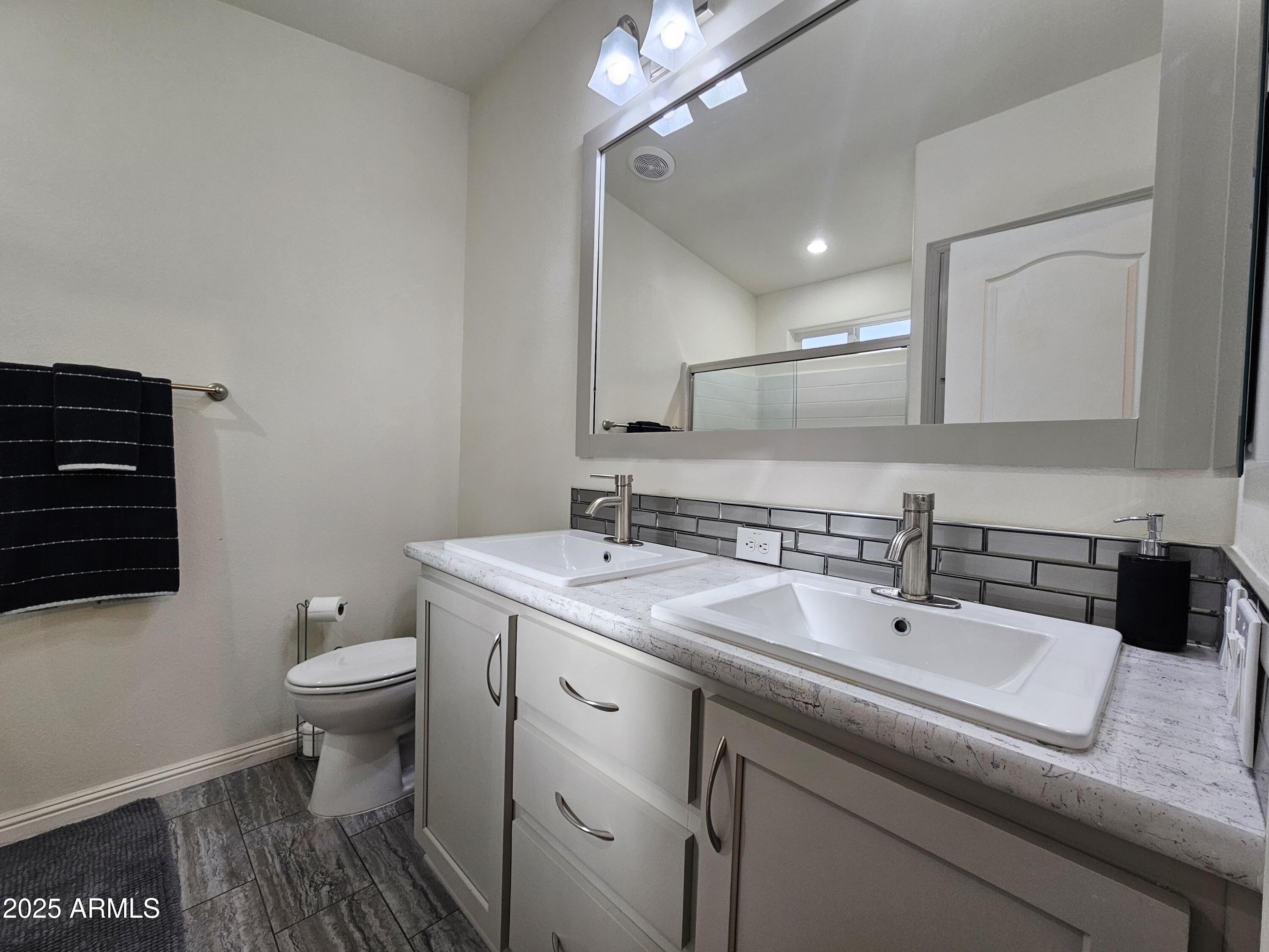 650 North Hawes Road, Unit 3124 Mesa, AZ 85207 - Photo 28 of 45 a bathroom with a sink a toilet a mirror and shower