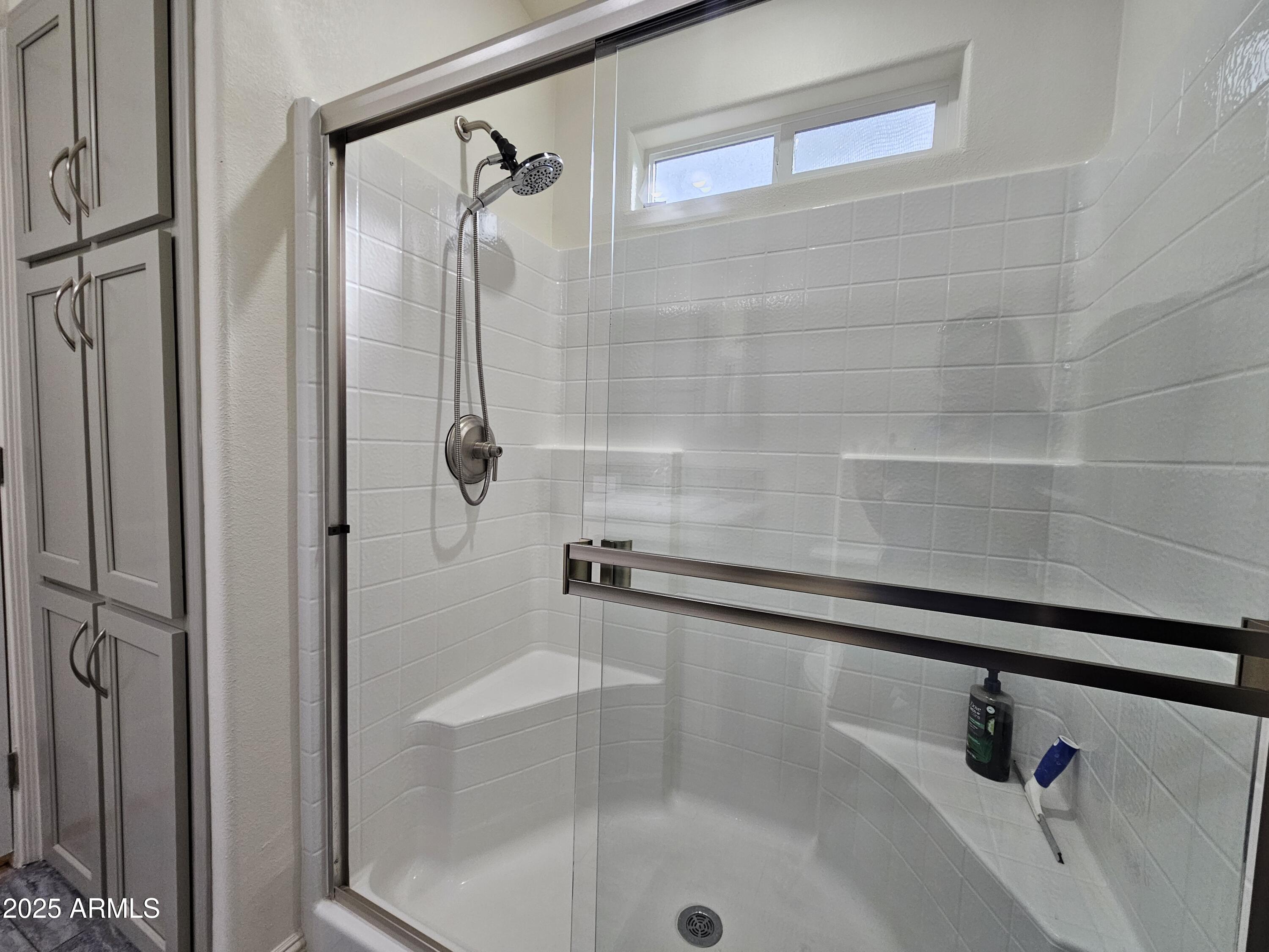 650 North Hawes Road, Unit 3124 Mesa, AZ 85207 - Photo 29 of 45 a bathroom with a glass shower door