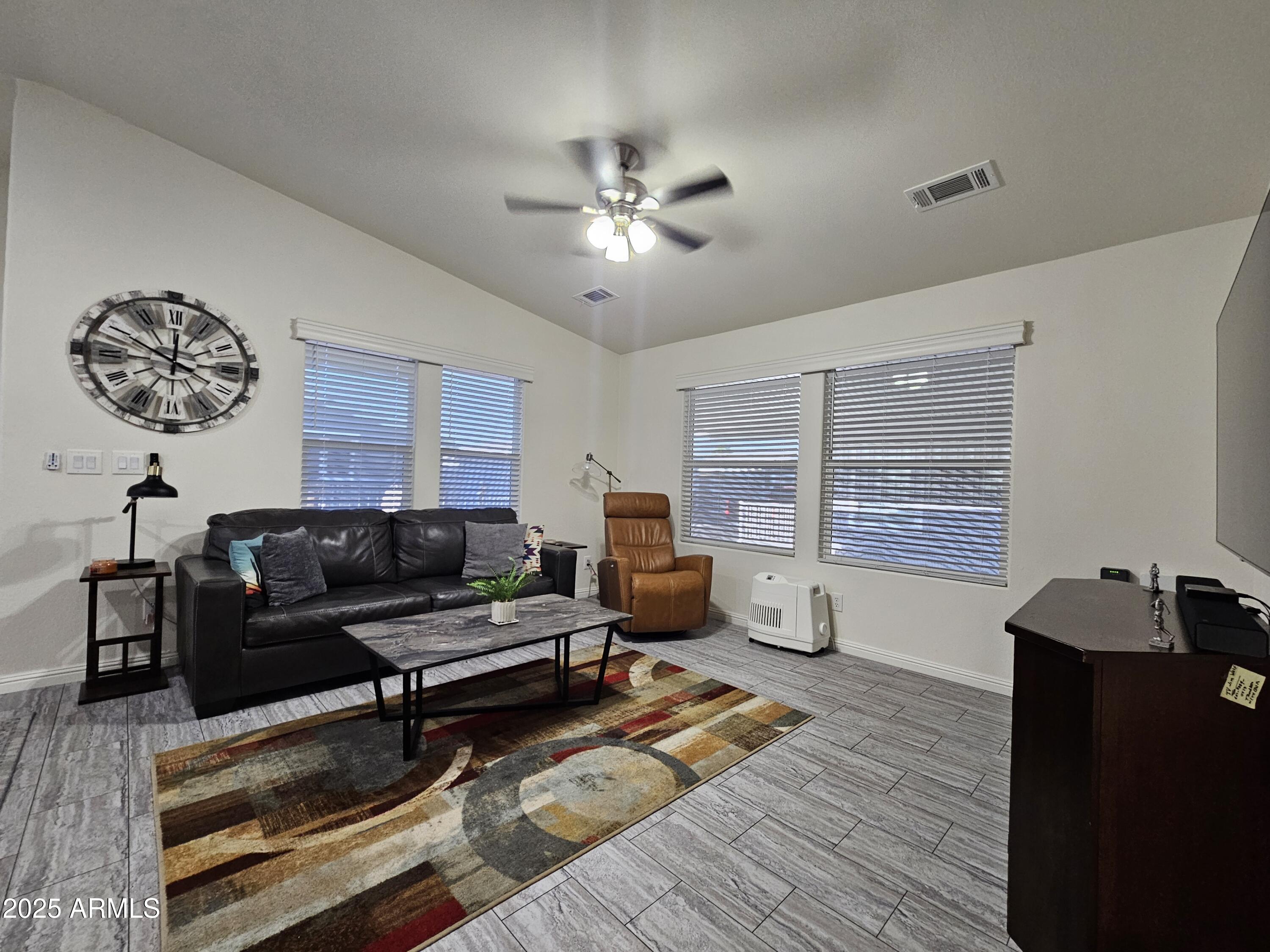 650 North Hawes Road, Unit 3124 Mesa, AZ 85207 - Photo 4 of 45 a living room with furniture and a window