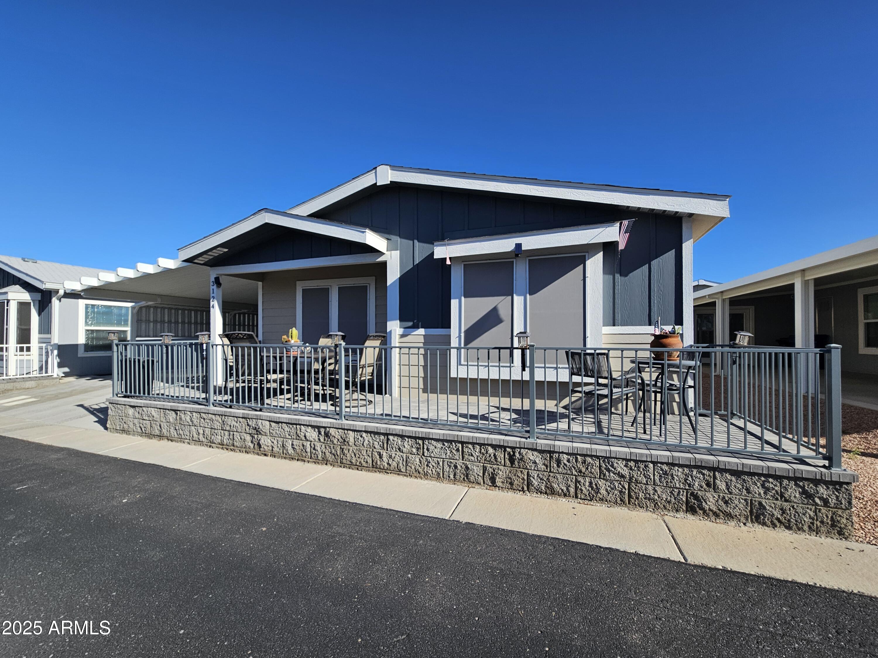 650 North Hawes Road, Unit 3124 Mesa, AZ 85207 - Photo 6 of 45 a front view of a house with a porch