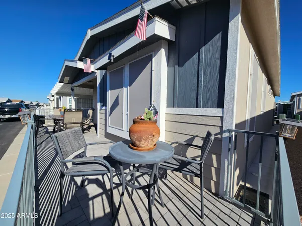a view of outdoor dining space with a table and chairs
