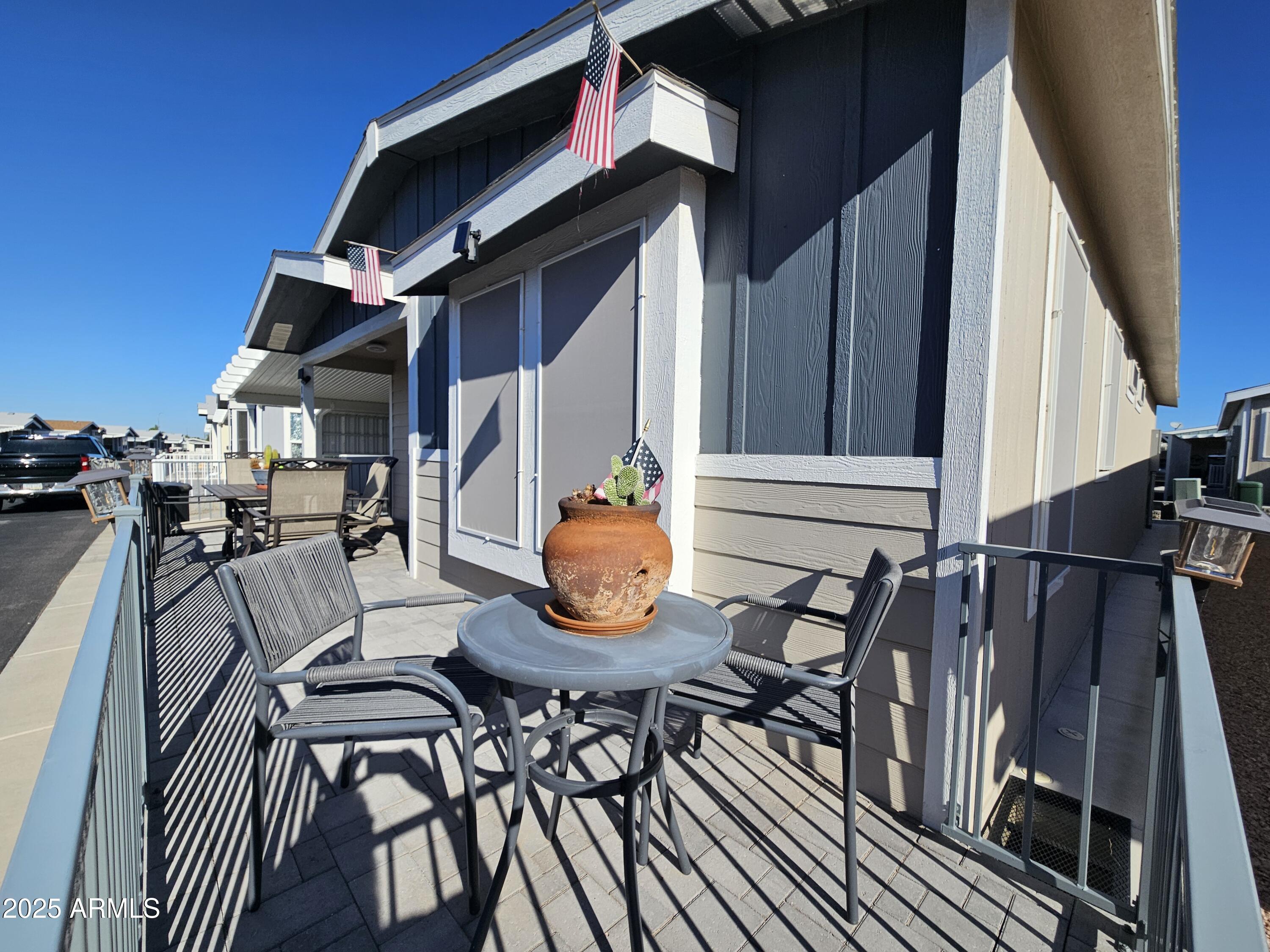 650 North Hawes Road, Unit 3124 Mesa, AZ 85207 - Photo 7 of 45 a view of outdoor dining space with a table and chairs