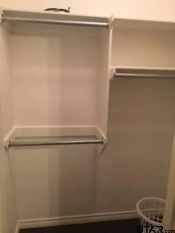 a view of a closet with wooden floor