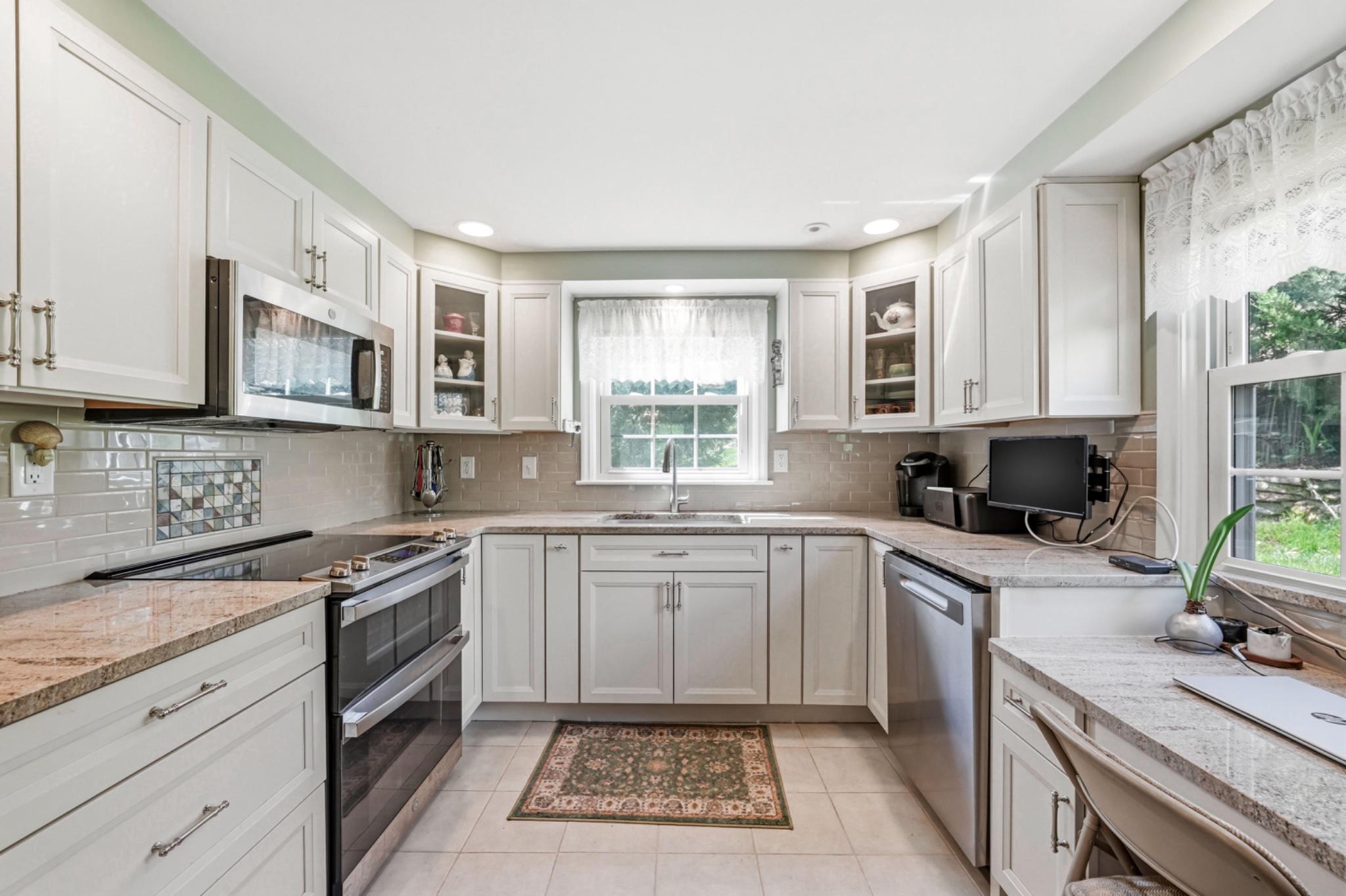 6 Laurel Lane Media, PA 19063 - Photo 17 of 52 a kitchen with a sink stove top oven and cabinets