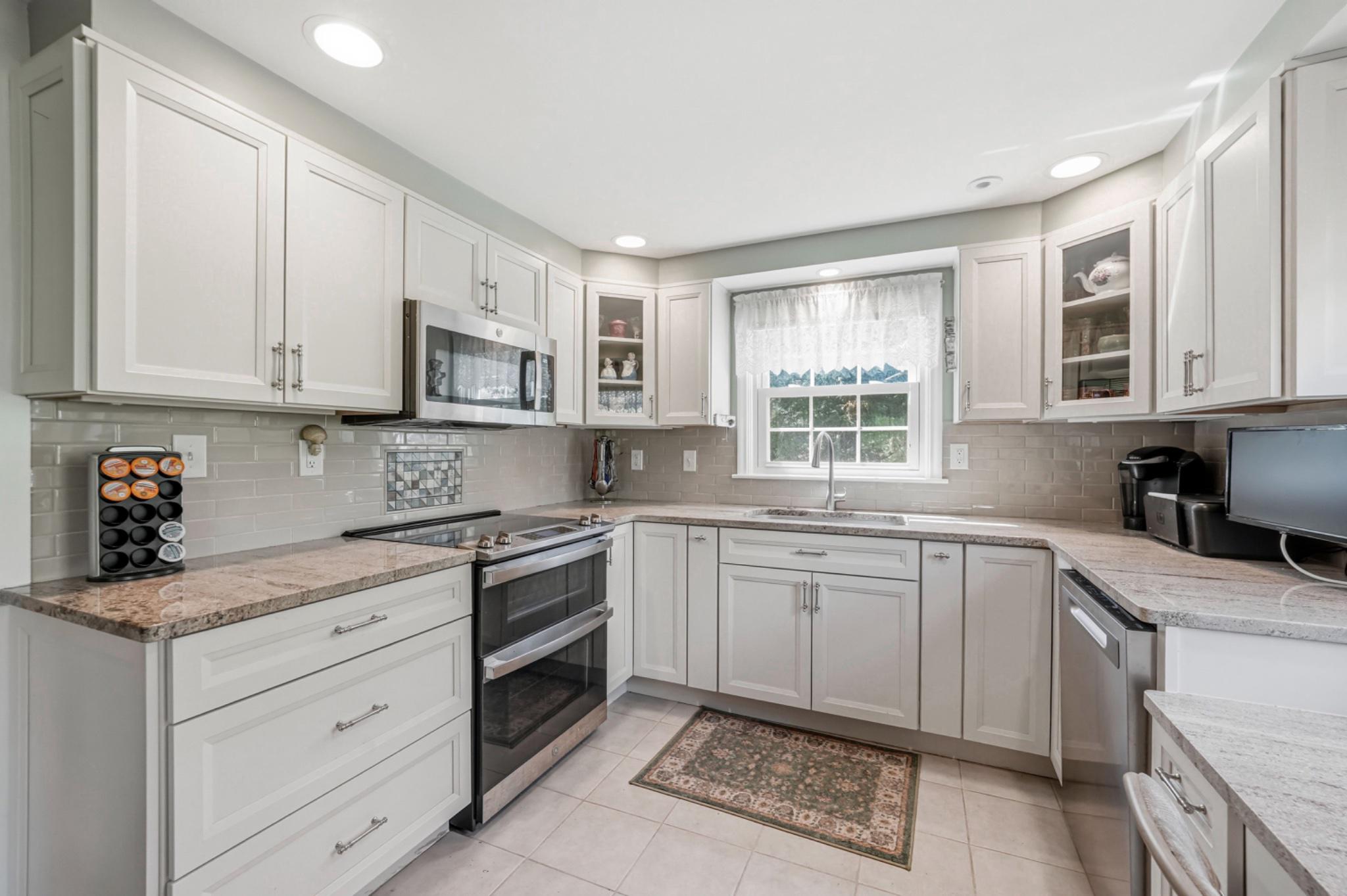 6 Laurel Lane Media, PA 19063 - Photo 18 of 52 a kitchen with stainless steel appliances granite countertop a sink and cabinets
