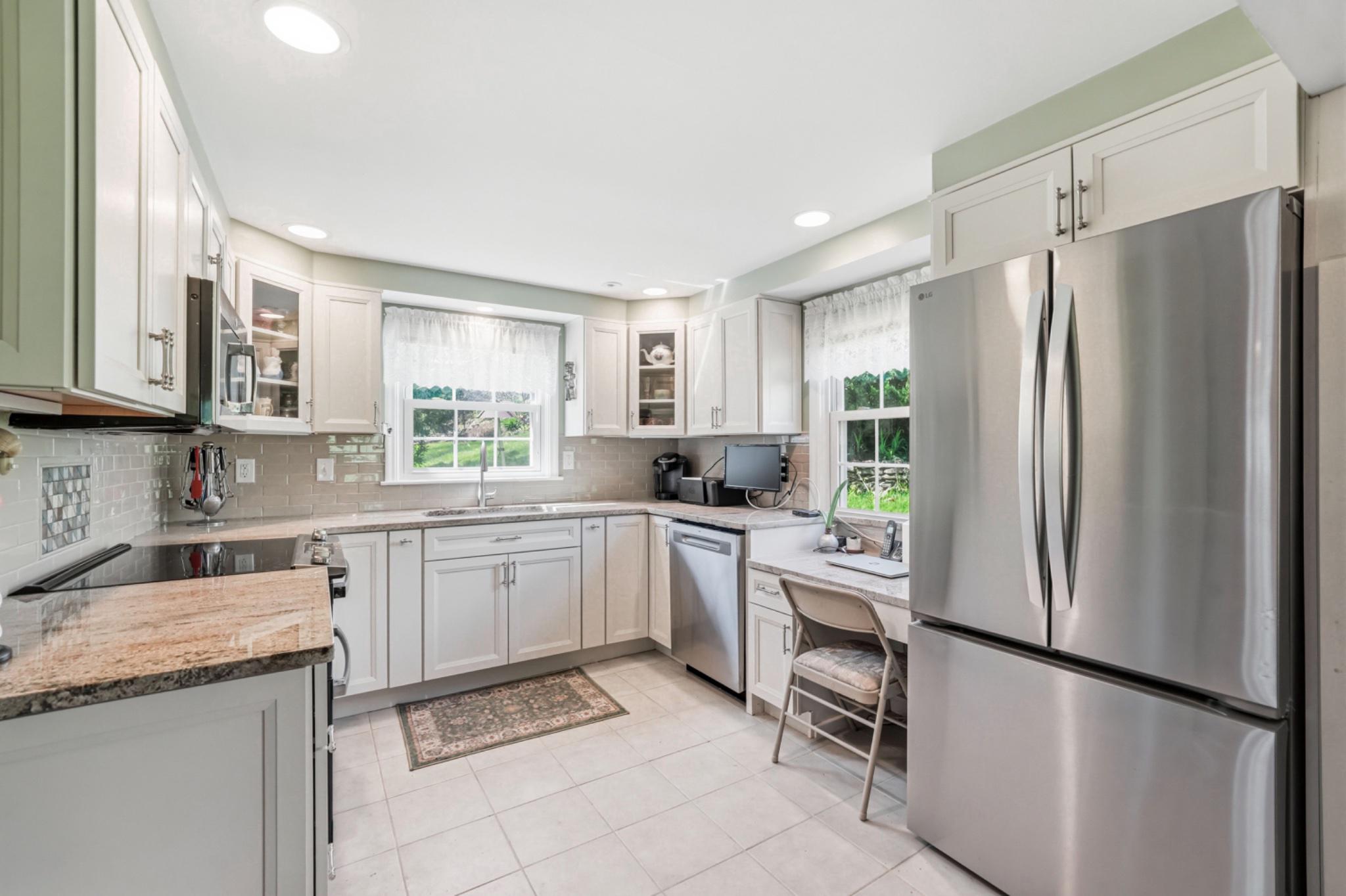 6 Laurel Lane Media, PA 19063 - Photo 19 of 52 a kitchen with a refrigerator a sink and chairs