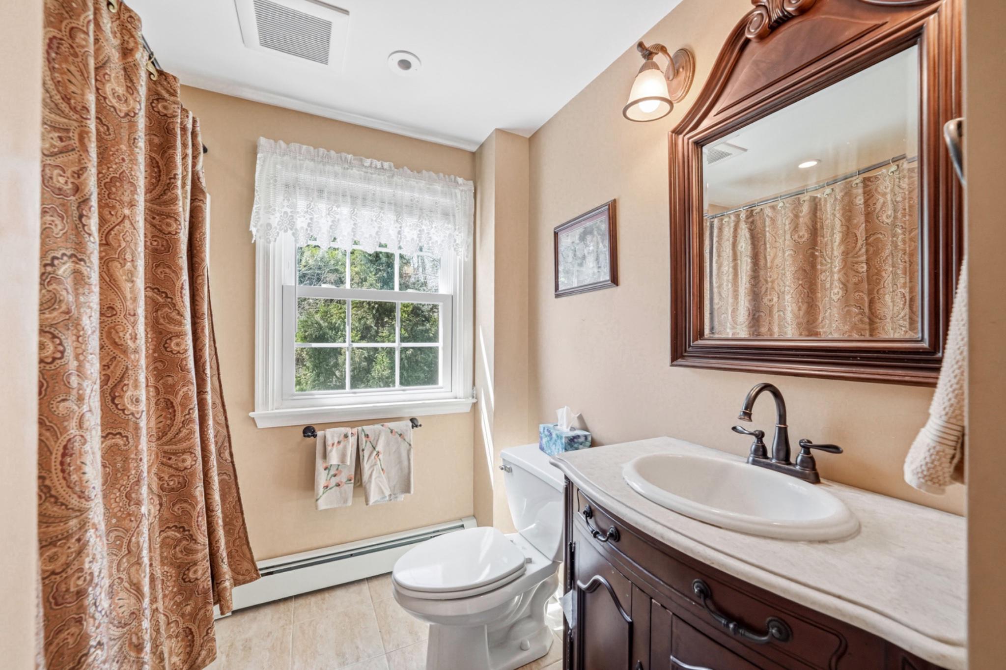 6 Laurel Lane Media, PA 19063 - Photo 36 of 52 a bathroom with a granite countertop sink toilet and a mirror
