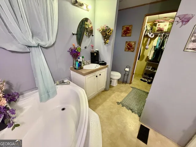 a bathroom with a sink mirror and vanity