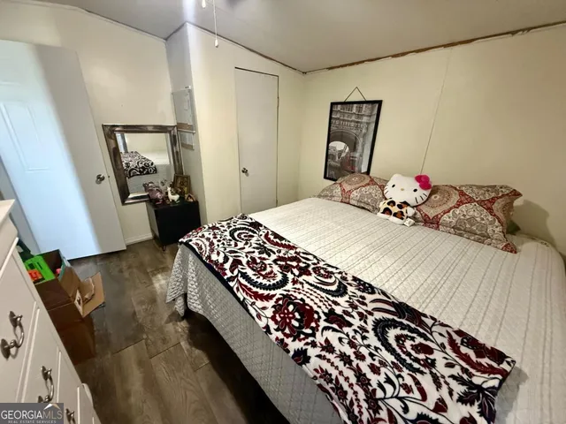 a bedroom with a bed and a dresser in it