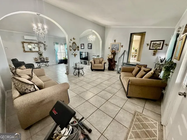 a living room with furniture and a chandelier
