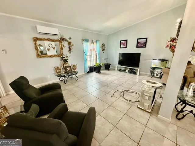 a living room with furniture and a flat screen tv