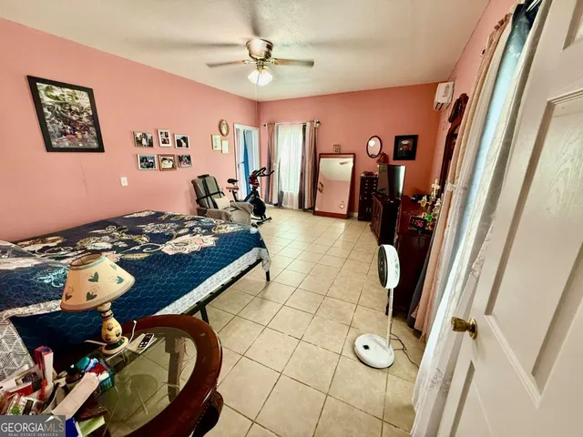 a living room with furniture and floor to ceiling window