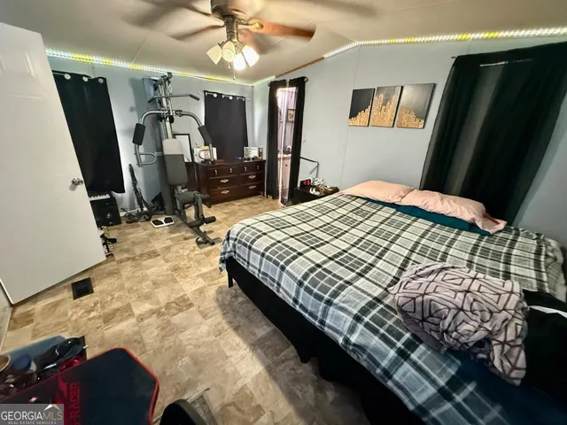 a bedroom with a bed closet and a mirror