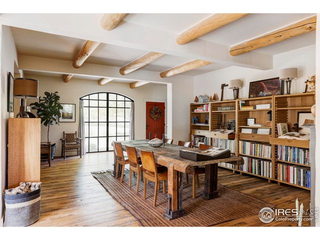 a dining room with lots of furniture and a potted plant