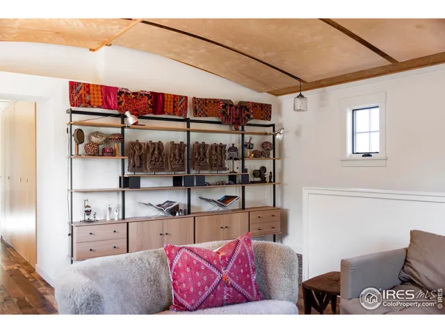 a living room with furniture a window and a flat screen tv