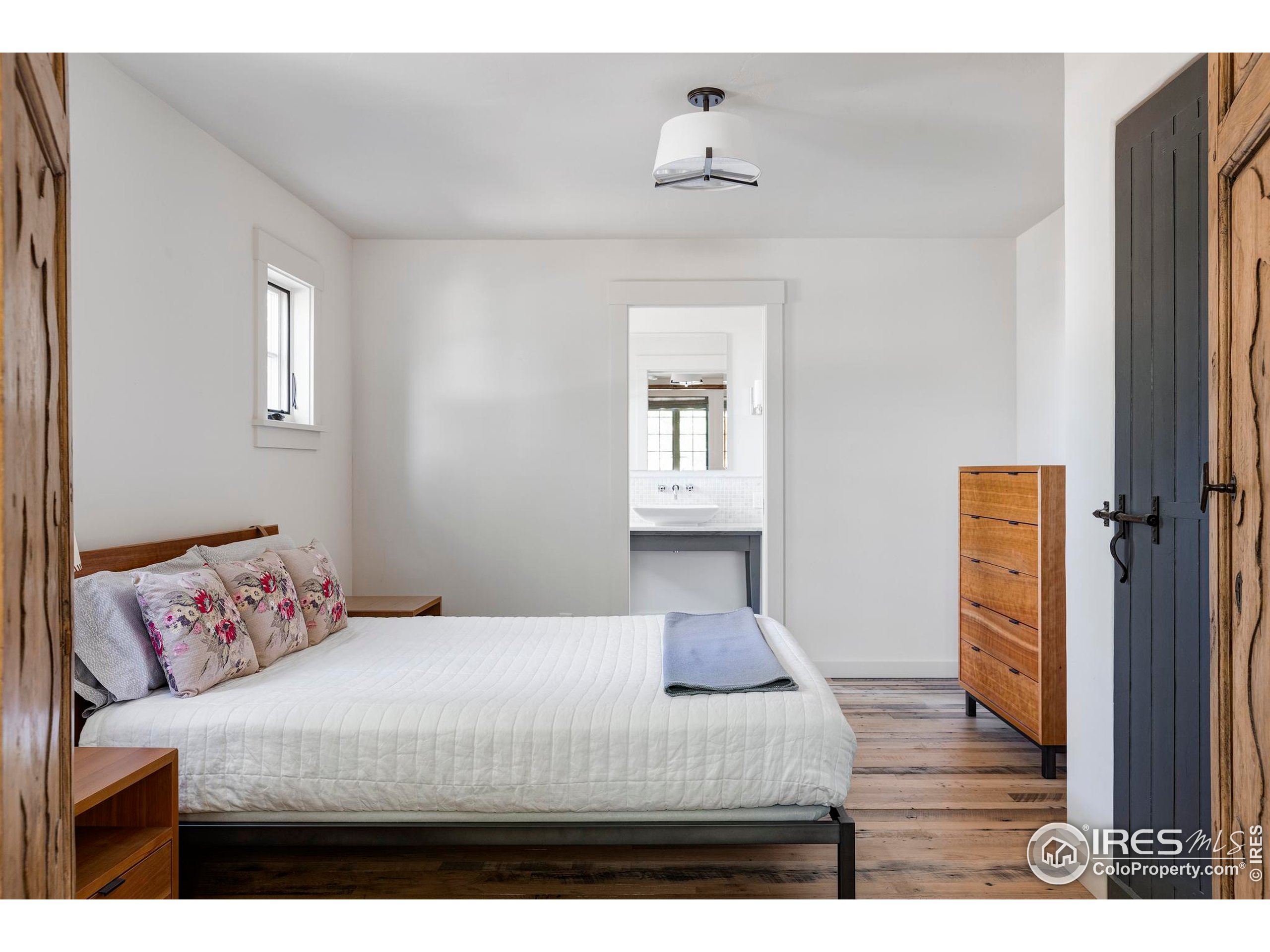 15789 North 83rd Street Longmont, CO 80503 - Photo 24 of 40 a bedroom with a bed and a night stand