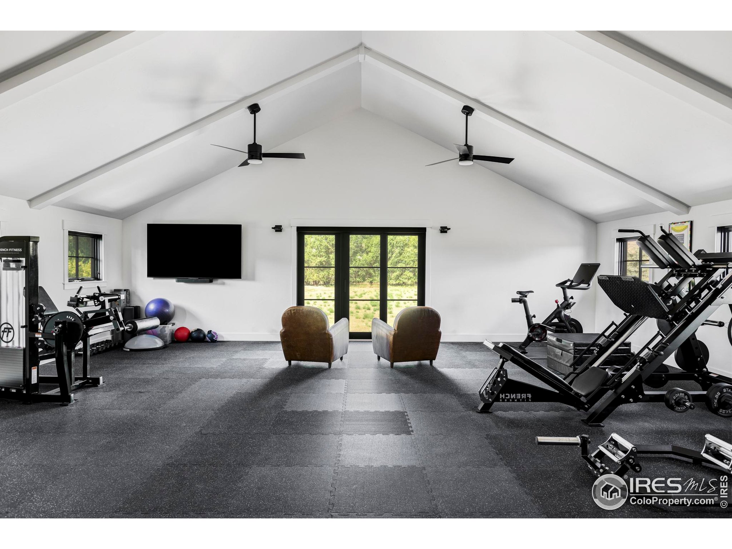 15789 North 83rd Street Longmont, CO 80503 - Photo 31 of 40 a living room with furniture and a flat screen tv