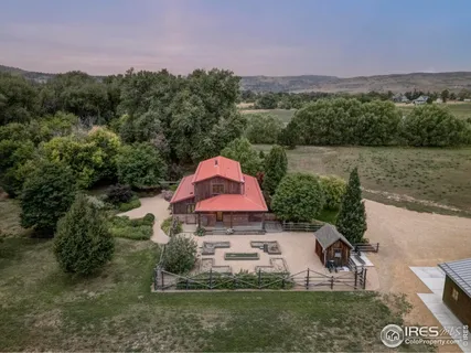 a aerial view of a house with a yard and a fountain