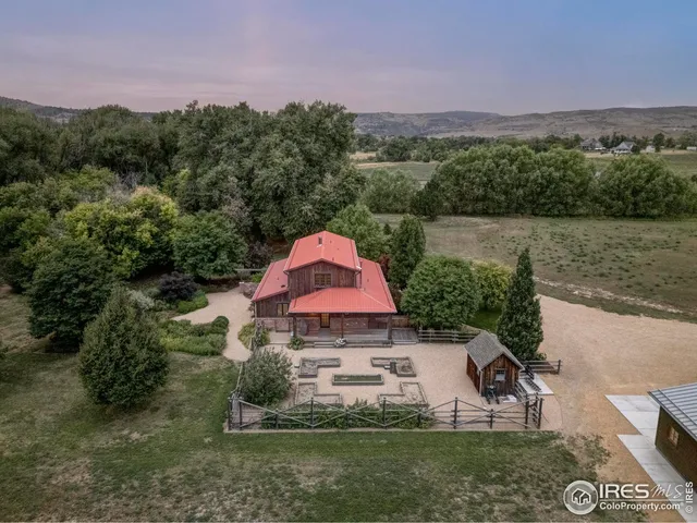 a aerial view of a house with a yard and a fountain