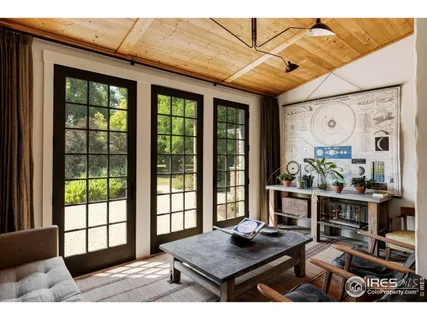 a living room with furniture and large windows