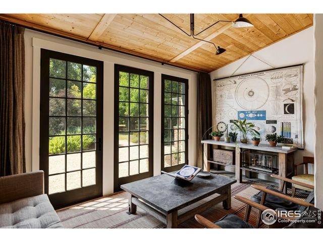 a living room with furniture and large windows