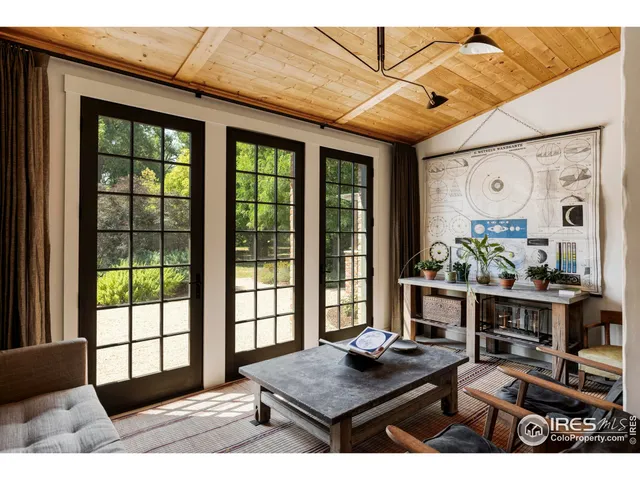 a living room with furniture and large windows