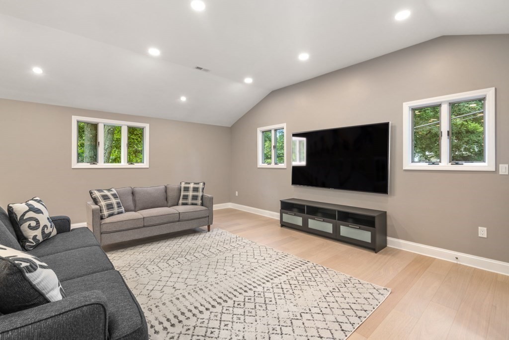 3 Emerson Road Wayland, MA 01778 - Photo 11 of 24 a living room with furniture and a flat screen tv