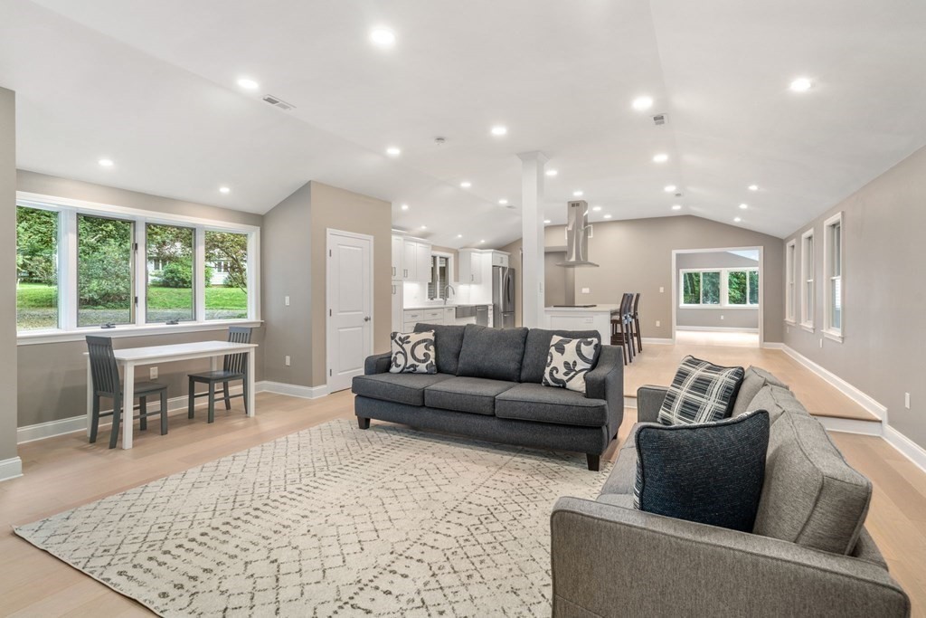 3 Emerson Road Wayland, MA 01778 - Photo 12 of 24 a living room with furniture and a dining table with kitchen view