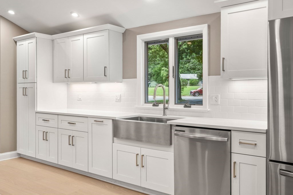3 Emerson Road Wayland, MA 01778 - Photo 7 of 24 a kitchen with white cabinets and a window