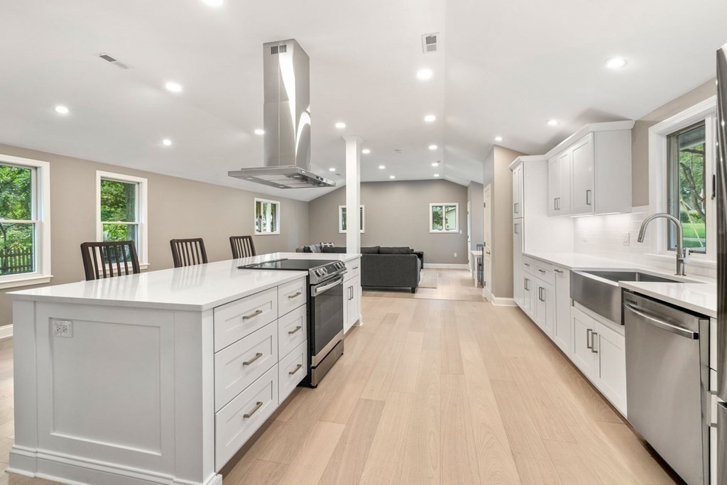3 Emerson Road Wayland, MA 01778 - Photo 8 of 24 a large kitchen with stainless steel appliances kitchen island granite countertop a large counter top a sink a stove and a refrigerator