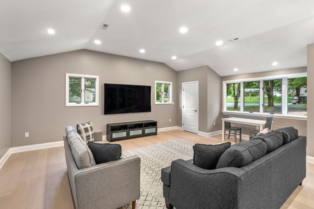 3 Emerson Road Wayland, MA 01778 - Photo 10 of 24 a living room with furniture and a flat screen tv