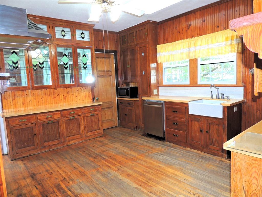 2102 Swenson Street Abilene, TX 79603 - Photo 12 of 40 a large kitchen with stainless steel appliances wooden floors and wooden cabinets
