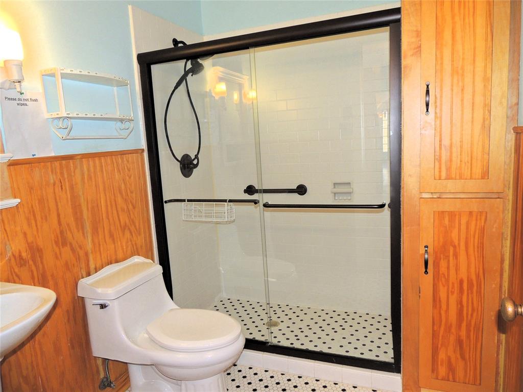 2102 Swenson Street Abilene, TX 79603 - Photo 17 of 40 a bathroom with a toilet and a shower